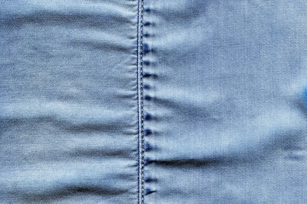 Dikilmiş açık mavi kot kot pantolon kumaş kumaş arka plan ve duvar kağıdı