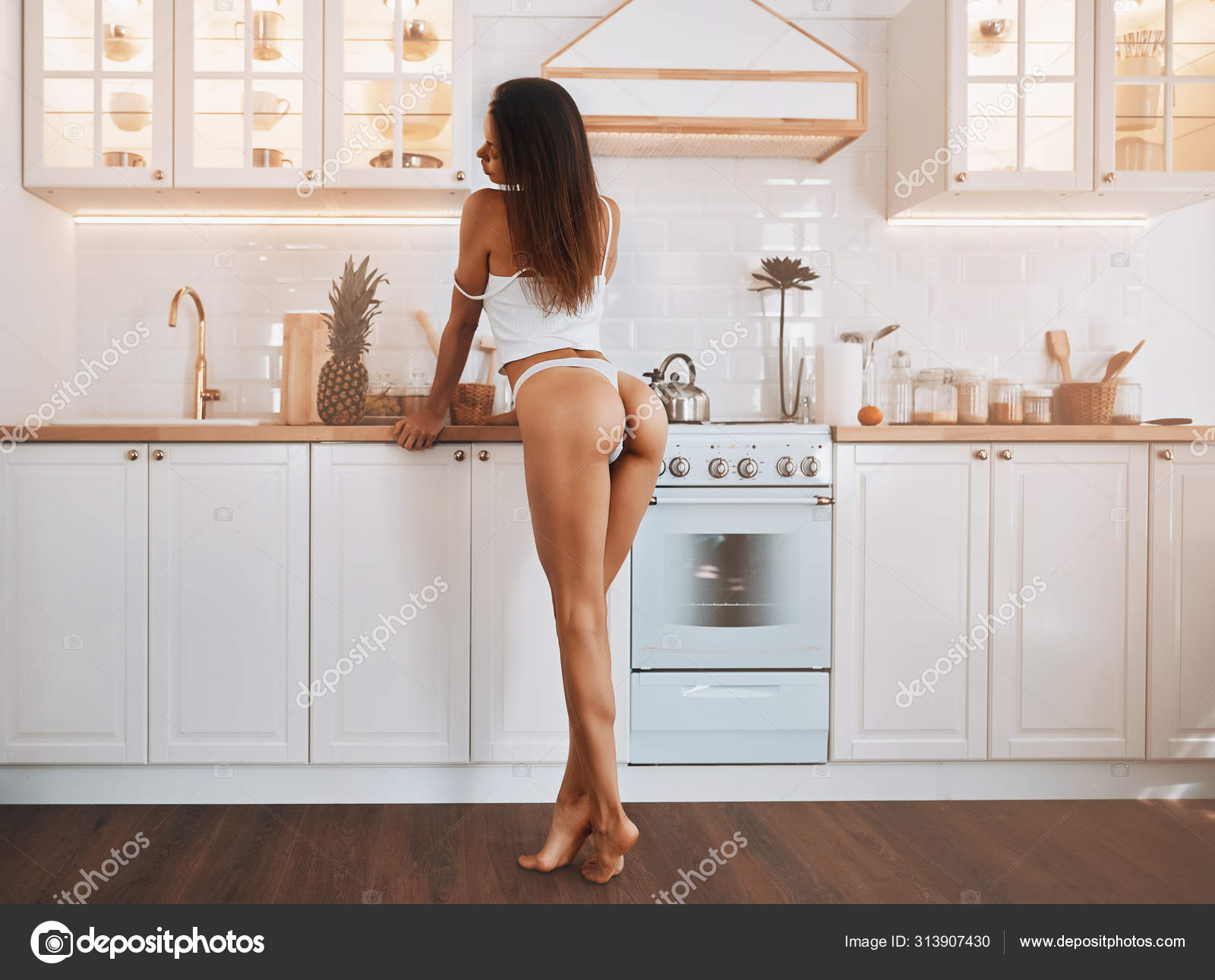 Sexy legs cooking in the kitchen