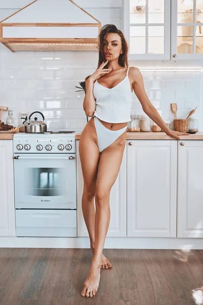 Sexy girl in lingerie in a kitchen — Stock Photo, Image