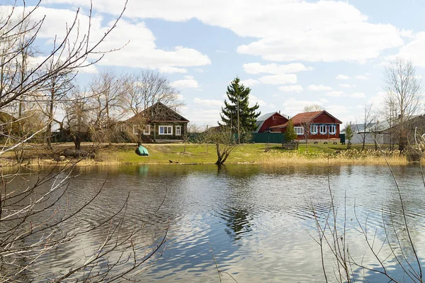 Spring landscape with riverside village — Stock Photo, Image