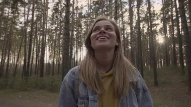 Mutlu kız güneşli orman ve gülümseme ayakta