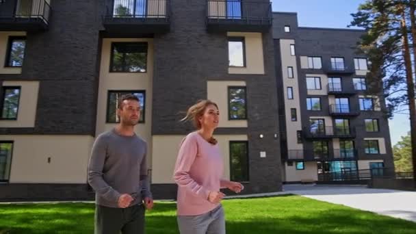 Happy active couple running at park near with home — Stock Video