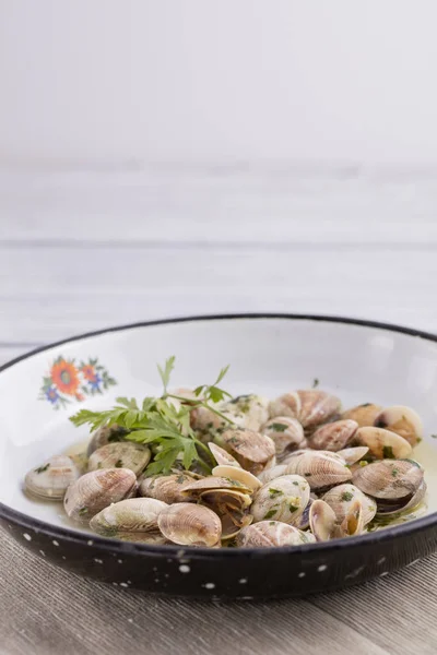clams in very old plate with green parsley