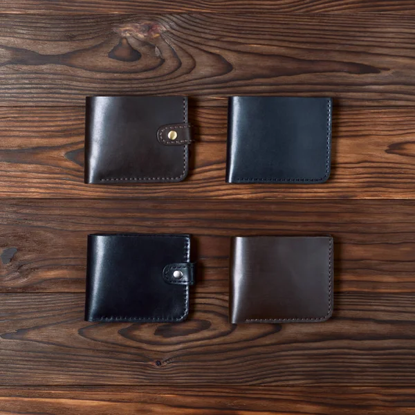 Vier Handgefertigte Leder Glanz Brieftaschen Auf Hölzernem Strukturiertem Hintergrund Von — Stockfoto