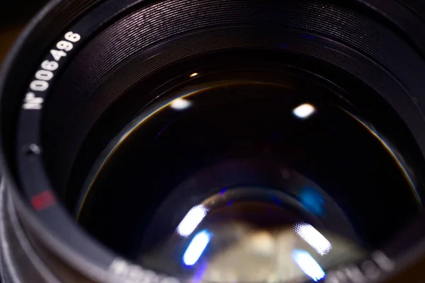 Lens glass low light photo closeup. Blue traces on glass. Apertu