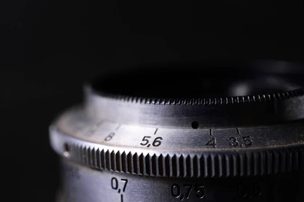 Vintage lens scales symbols closeup. Stock photo with blurred gr