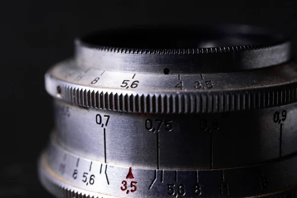 Old vintage lens scales symbols closeup. Photo with blurred gray — Stock Photo, Image