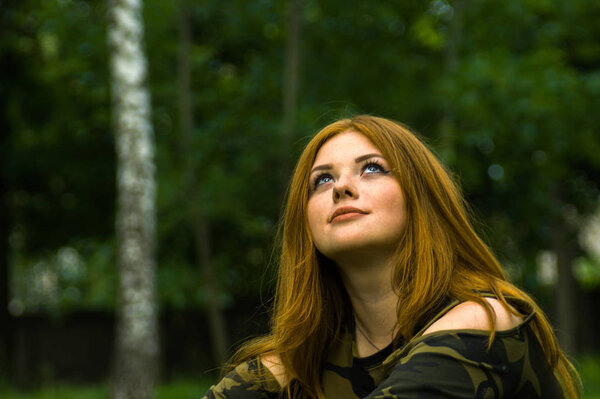 Pretty redhead girl shoot on outdoor park