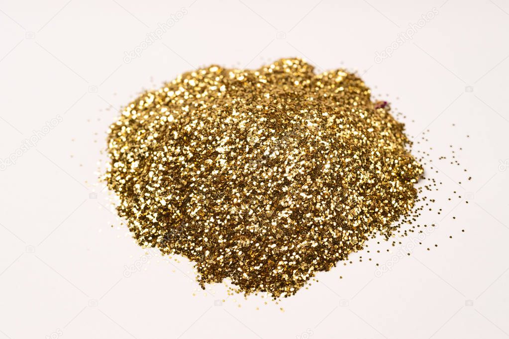 A bunch of golden nail gritter for manicure. Golden glitter shin