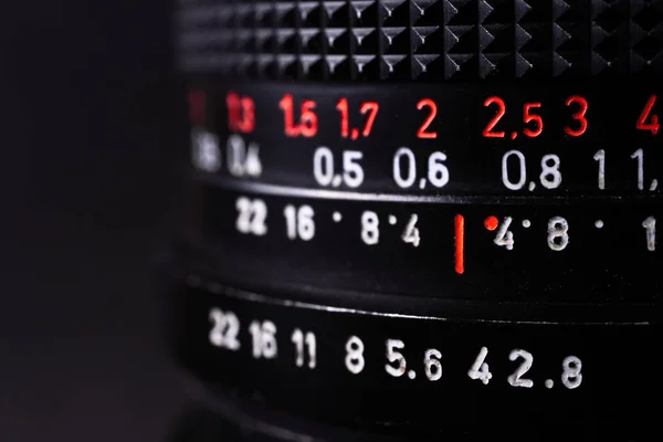 Vintage lens scales symbols closeup. Stock photo with blurred gr