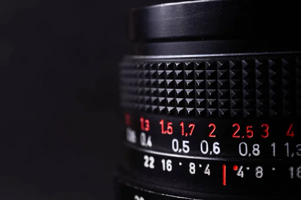 Vintage lens scales symbols closeup. Stock photo with blurred gr