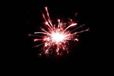 Bengali yangınının, kırmızı tonlu, siyah arka planda izole edilmiş düşük ışık fotoğrafı. Bir sürü ışık ve kıvılcım. Görünmeyen fotoğraf.