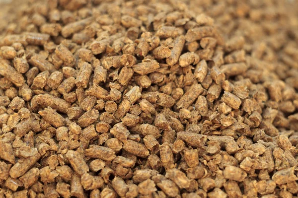 Fuel wood pellet close-up. A source of alternative clean energy. A lot of pellet. Natural fuel and energy of future.