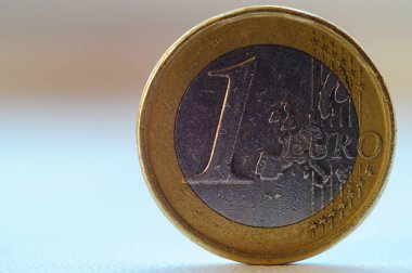 Eski 1 avroluk bozuk para bulanık arka planda duruyor.