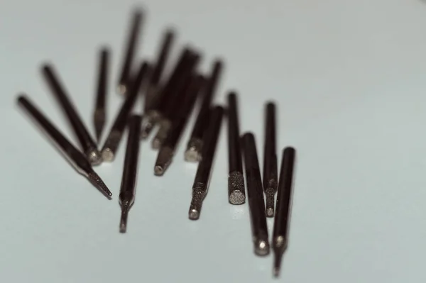 Diamond drill bits on white background. Close-up view. Tools jeweler and dentist.