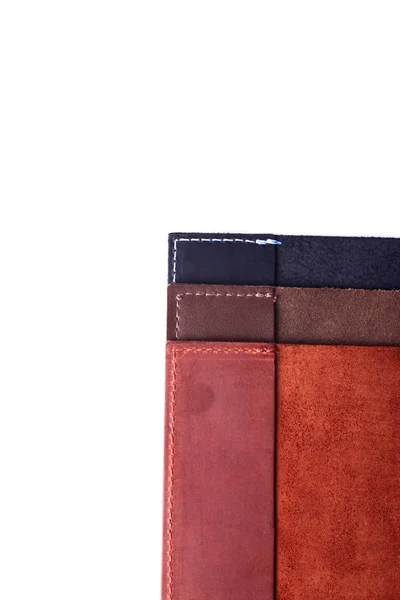 Three handmade leather passport covers stack isolated on white b