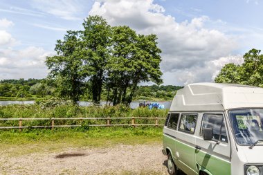 Vintage caravan parked in the middle of a natural landscape in England, UK clipart