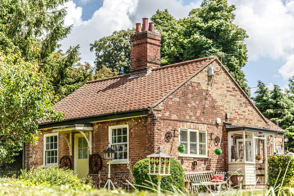 Beautiful typical English house surrounded by a garden, on beautiful sunny day