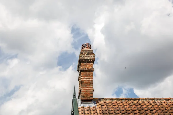 Brick chimney typical of a house in England, with the sky in the background