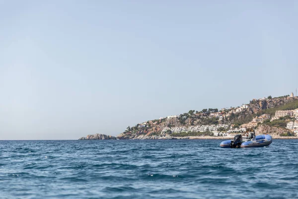 Denizin bir beach, İspanya yakınındaki demirlemiş mavi renkteki küçük motorlu tekne
