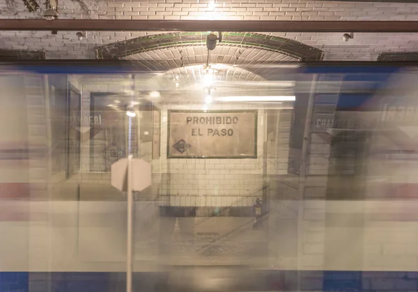 Subway car passing at high speed in an old and vintage subway station, Spain