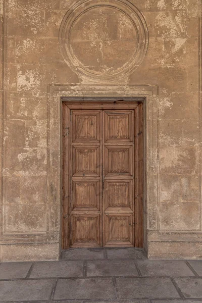 Classic solid wood door in one of the buildings of the Alhambra, Granada, Spain