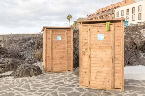 Changing clothes on a beach of volcanic origin, Tenerife island, Spain