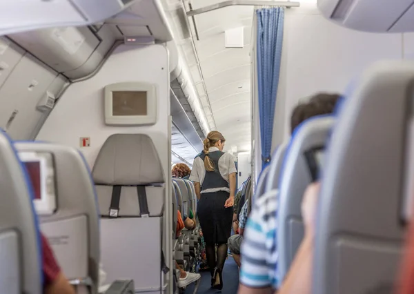 Stewardess Airplane Checks Passengers Have Safety Belt Table Folded Takeoff — Stock Photo, Image