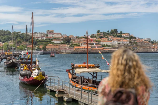 A tourist watches the famous rabelo boats in the city of Oporto.