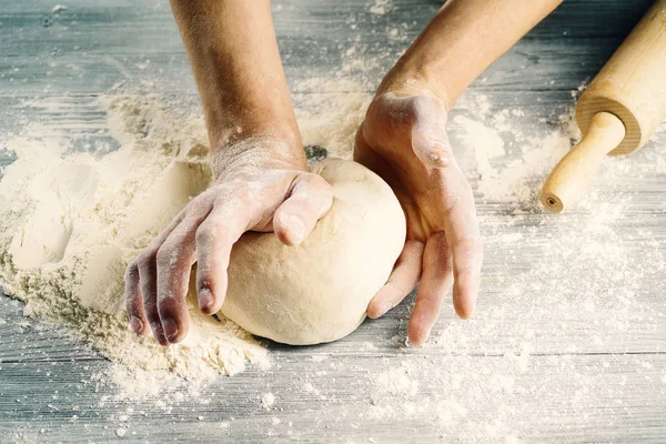Cook hands knead the dough.Close-up.