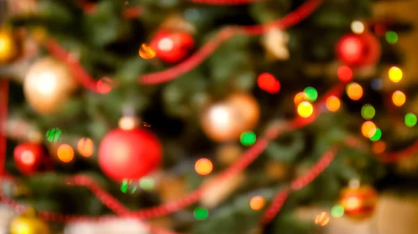 Closeup blurred photo of colorful bokehs and lights on Christmas tree — Stock Photo, Image