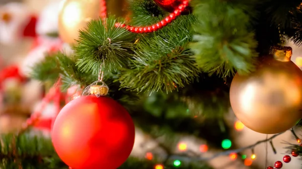 Closeup image of red baubles and beads adorning Christmas tree — Stock Photo, Image