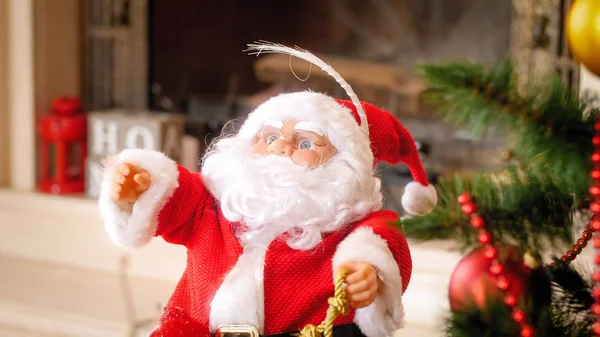 Closeup image of Santa Claus miniature under Christmas tree — Stock Photo, Image