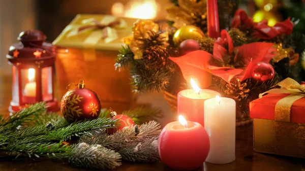 Beautiful image for winter holidays with candles, baubles and gift boxes — Stock Photo, Image