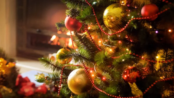 Closeup image of colorful lights glowing on Christmas tree at night — Stock Photo, Image