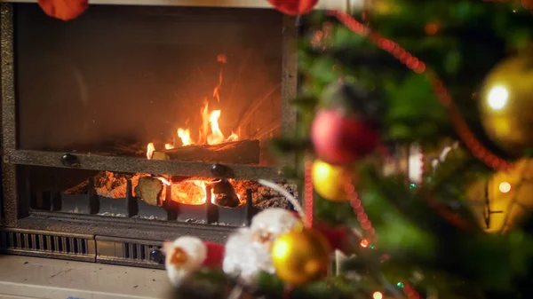 Closeup image of Christmas tree and burning fireplace in living room — Stock Photo, Image