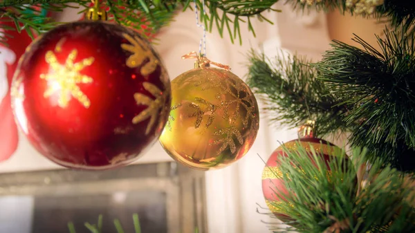 Closeup image of red and golden baubles on Christmas tree at living room — Stock Photo, Image