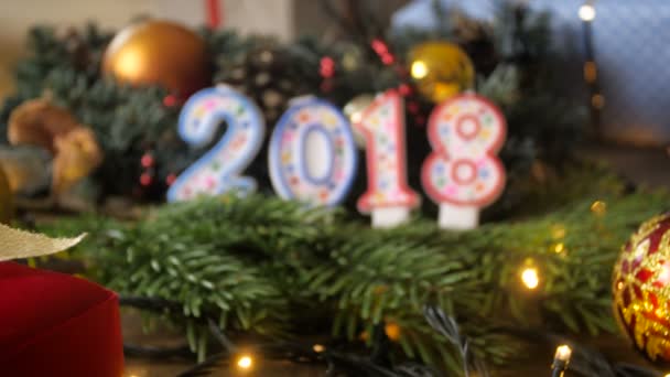Closeup 4k footage of camera slowly focusing on 2018 New Year candles — Stock Video