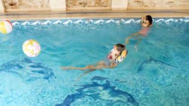 4 k video, iki genç kız evinde kapalı havuzu içinde şişme renkli yüzük Yüzme