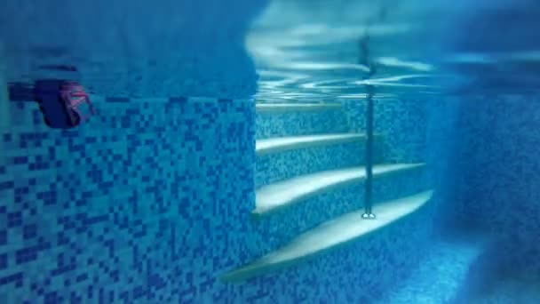 4k underwater video of teenage girl jumping from the poolside and diving in water — Stock Video