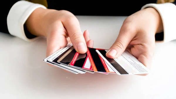 Closeup image of female hands holding lots of credit cards — Stock Photo, Image