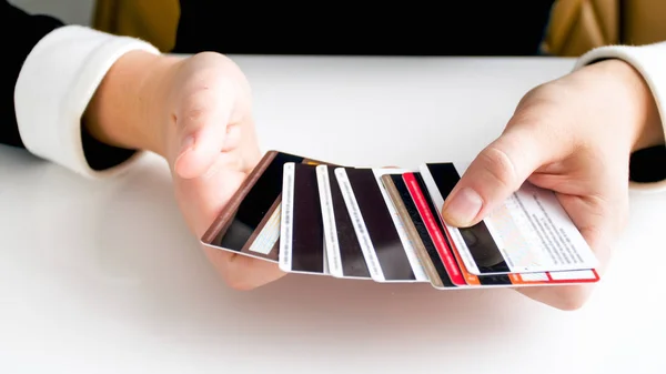 Closeup photo of young woman holding lots of difeerent bank credit cards — Stock Photo, Image