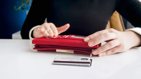 大きな赤い財布やクレジット カードを持つ若い女性のクローズ アップ写真 — ストック写真