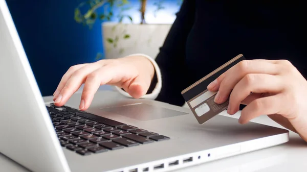 Closeup photo of young woman working on laptop typing number of her credit card — Stock Photo, Image