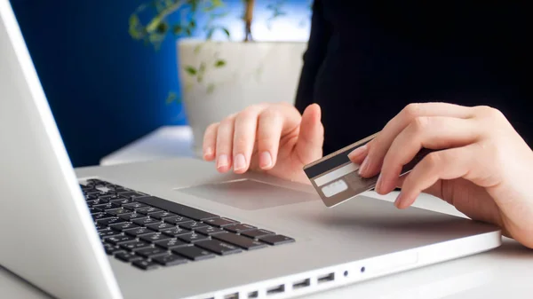 Closeup photo of young woman making order in online store and using her credit card to pay — Stock Photo, Image