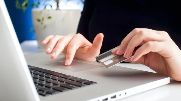 Closeup photo of young woman entering number of her credit card on laptop to make purchases online — Stock Photo, Image