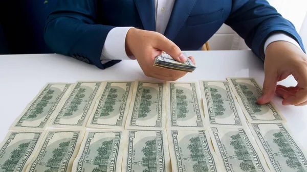 Closeup photo of successful businessman counting hi smoney on office desk — Stock Photo, Image