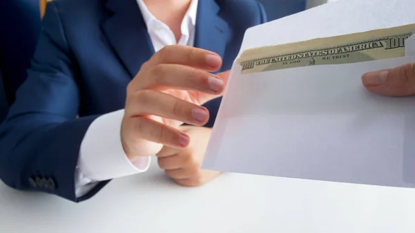 Closeup image of person giving envelope with money to bribed politician — Stock Photo, Image