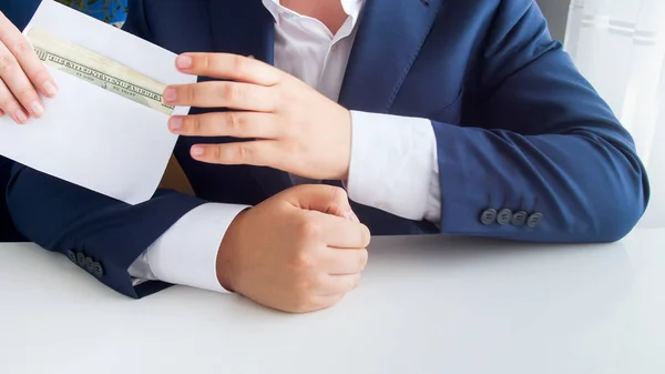Closeup image of corrupted official receiving bribe in envelope at office — Stock Photo, Image