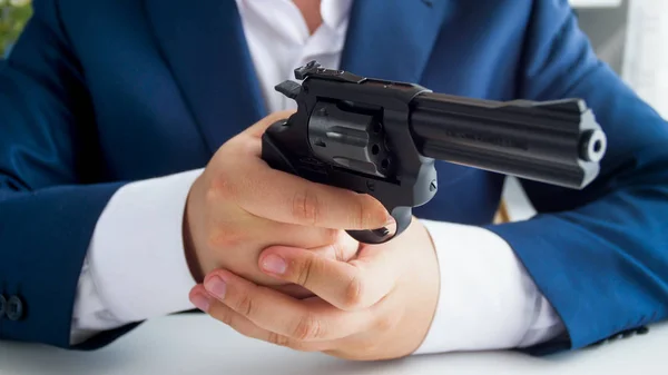 Closeup image of man in suit holding and aiming with gun — Stock Photo, Image